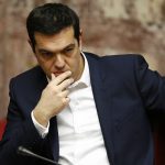 Greek Prime minister Alexis Tsipras reacts before a swearing in ceremony in the Greek Parliament