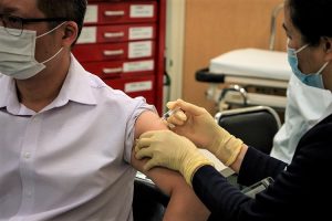 Photo for illustrative purposes only. Man being vaccinated against COVID-19. Macau Photo Agency/Unsplash