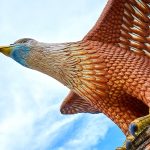 A sculpture of a red eagle spreading its wings. Popular tourist spot on Langkawi island