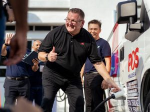 Charles Brewer, Group Chief Executive Officer of Pos Malaysia Berhad trying out one of the EV charging stations. | Pos Malaysia Post Office Shah Alam. | Photo by Pos Malaysia/NHA File Photo