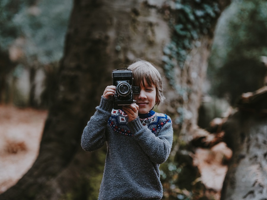 Photo for illustrative purposes only. Child holding vintage camera | Photo by Annie Spratt/Unsplash/NHA File Photo