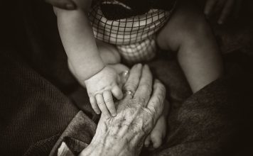 I love this photo of my mums hand reaching out to share a moment with her great grandson. Even when we can’t understand each other in language, we can all understand what a simple touch means. | Photo by Rod Long/NHA File Photo