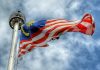 The Malaysian flag waving in the wind in Kuala Lumpur City Centre, Malaysia. | Photo by mkjr_/Unsolash/NHA File Photo
