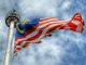 The Malaysian flag waving in the wind in Kuala Lumpur City Centre, Malaysia. | Photo by mkjr_/Unsolash/NHA File Photo