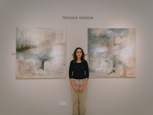 Abstract artist, Mulaika Nordin with her paintings at "Echoes" art exhibition in celebration of women's voices in arts. Kuala Lumpur, 9 Mar 2024