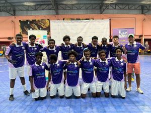 Tunku Danny Nasaifuddin Mudzaffar, founder and CEO of microLEAP with Fugee School's boys’ football team. | Photo by microLEAP / NHA File Photo