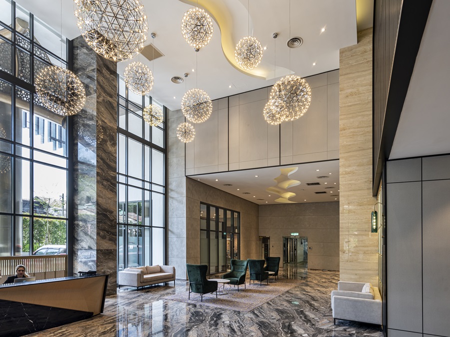The iconic entrance of Trinity Pentamont exudes sophistication with its modern interior design, luxurious marble finishes, and statement lighting fixtures. | Photo by Trinity Group / NHA File Photo