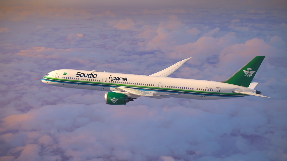 A photo of Saudia's Boeing 787 plane flying above the clouds.
