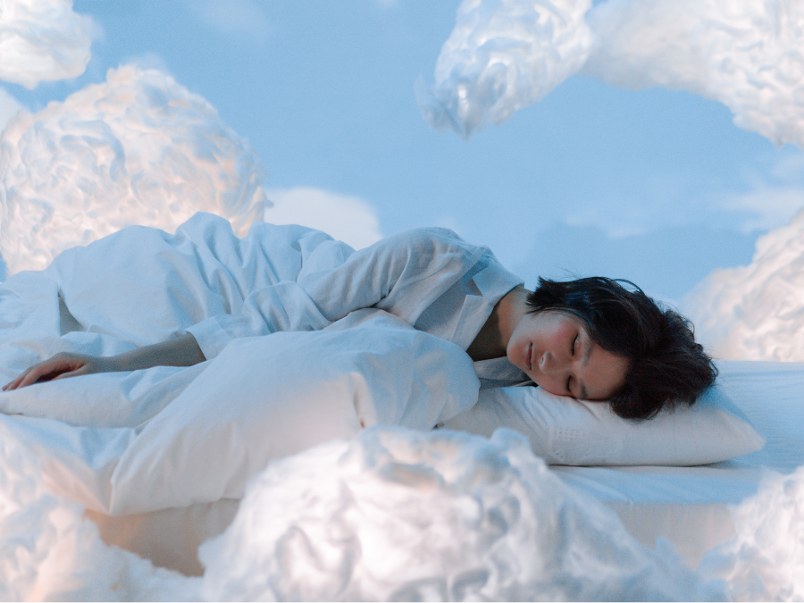 Photo of a woman sleeping near fluffy clouds. Photo for illustrative purposes only. | Photo by Ron Lach / Pexels (via Canva Pro) / NHA File Photo