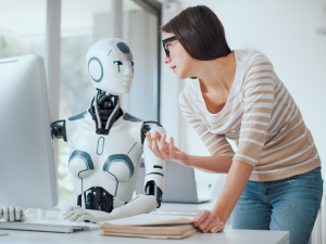 A conceptual photo of an AI humanoid working with a human being at the office. Photo for illustrative purposes only. | Photo by demaerre / Getty Images Signature via Canva Pro / NHA File Photo