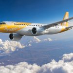 Clouds float over a city under a blue sky