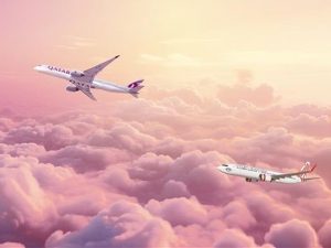 A photo of Qatar Airways Cargo aircraft flying above the sunset clouds with Virgin Australia. | Photo by Qatar Airways Cargo / NHA File Photo