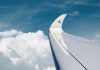Qatar Airways logo at the wing tip while in flight amidst the blue sky and white clouds. | Photo by Qatar Airways / NHA File Photo