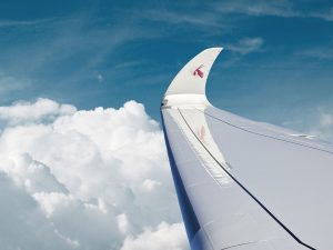 Qatar Airways logo at the wing tip while in flight amidst the blue sky and white clouds. | Photo by Qatar Airways / NHA File Photo