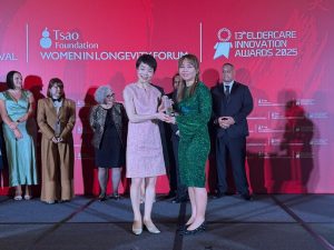 Vivien Lim, the director of sales and marketing at Sunway Sanctuary (right), receiving the Facility of the Year – Active Ageing award on stage. | 13th Eldercare Innovation Awards 2025 in Singapore, 9 April 2025. | Photo by Sunway Sanctuary / NHA File Photo