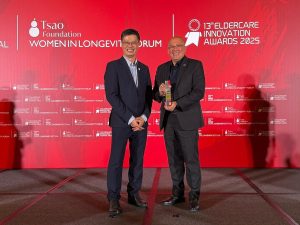 Leonard Theng, general manager of Sunway Sanctuary (right), receiving the Operator of the Year – Senior Living (New Entrants) award on stage. | 13th Eldercare Innovation Awards 2025 in Singapore, 9 April 2025. | Photo by Sunway Sanctuary / NHA File Photo