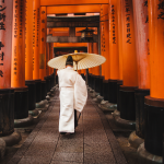 Japan_Priest walking through the Senbon Torii at Fushimi Inari Taisha in Kyoto_NHA File Photo