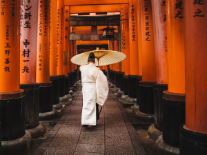 A priest walking through the Senbon Torii at the Fushimi Inari Taisha in Kyoto, Japan. | Photo by DSD / Pexels (via Canva Pro) / NHA File Photo