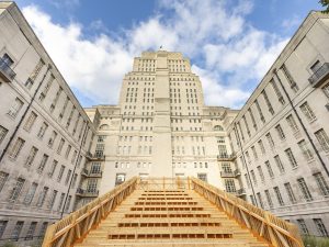 Located at the heart of the University of London estate, the Senate House Steps is an 7.3m high ascending steps. It's a modern, timber-and-steel structure designed to provide spaces for community gatherings, relaxation, and transit. The steps are part of a larger revitalisation project that transformed a previously underused car park into a vibrant public space. | Photo by ACCA and University of London / NHA File Photo