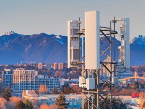 A radio tower in the foreground and a city landscape in the background. | Photo by Ericsson / NHA File Photo
