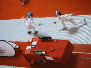 An overhead shot captures two épée fencers mid-action at the Negeri Sembilan Youth Challenge (NSYC), which was held in Centerpoint Seremban in Negeri Sembilan, Malaysia. 21-23 June 2025. | Photo by Negeri Sembilan Fencing Association / NHA File Photo