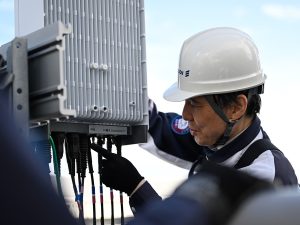 An Ericsson engineer in Japan works on network equipment. | Photo by Ericsson / NHA File Photo