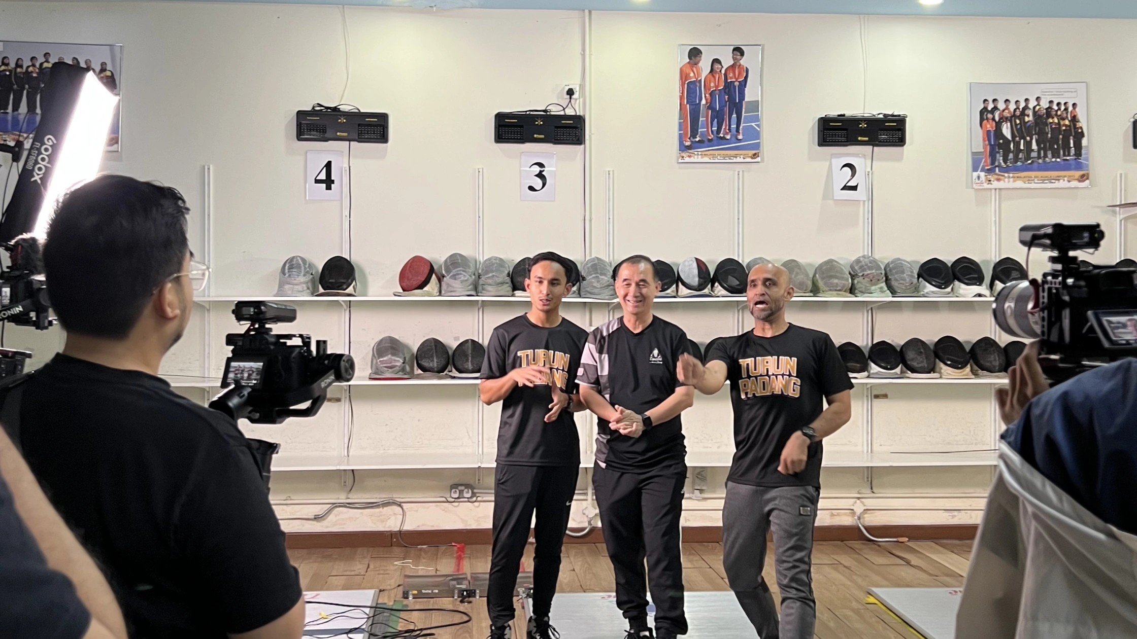 Not shy in front of the camera Coach Mok with the local media who often speak with him about the development of the sport and his experiences as a former national athlete : Source - Touche Fencing Facebook  
