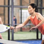 portrait-concentrated-asian-woman-playing paddleball